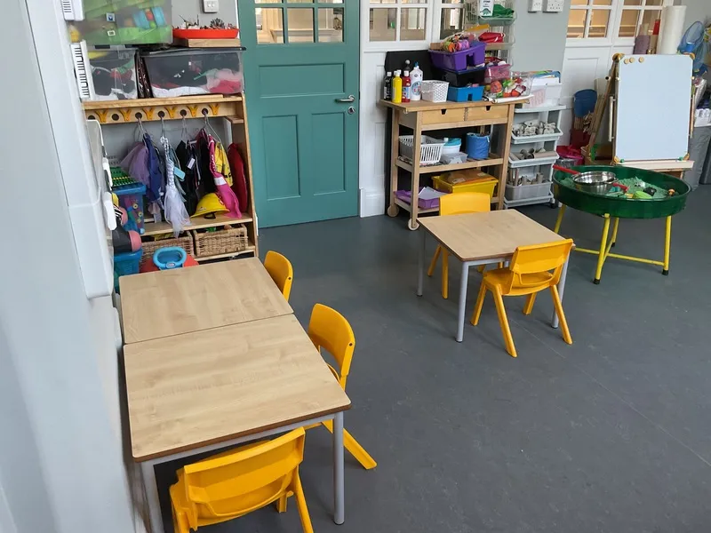 Tables and chairs set out in the 2 year old room, Ysgol Feithrin Y Trallwng, Welshpool